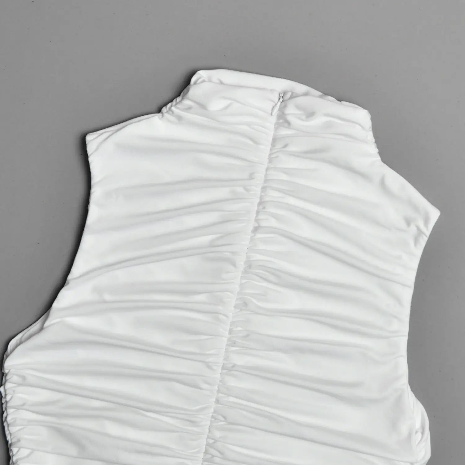 Back view closeup, center vertical ruched seam and rear zipper on white dress