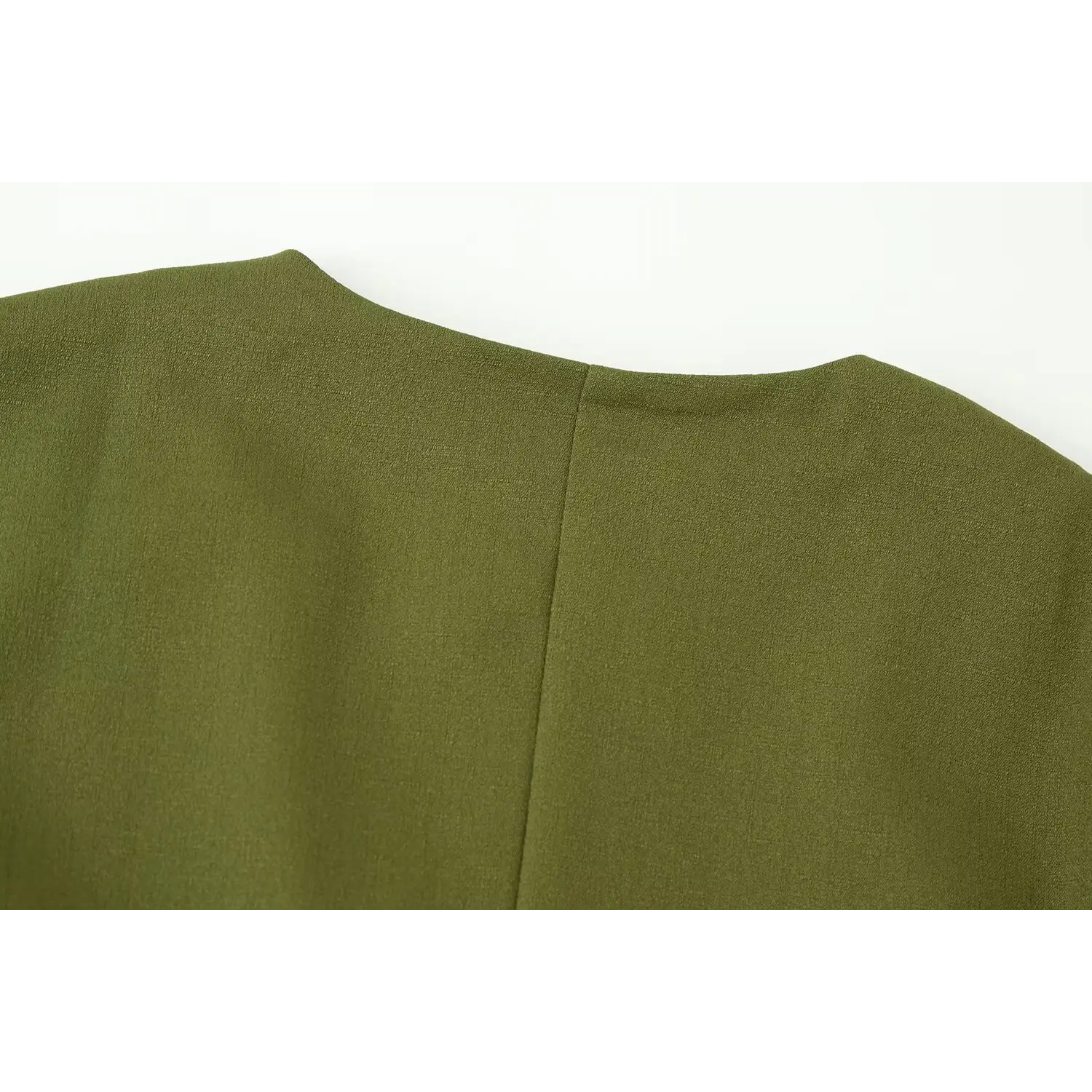 Upper back close-up, single vertical center stitching, matte woven suiting fabric weave detail