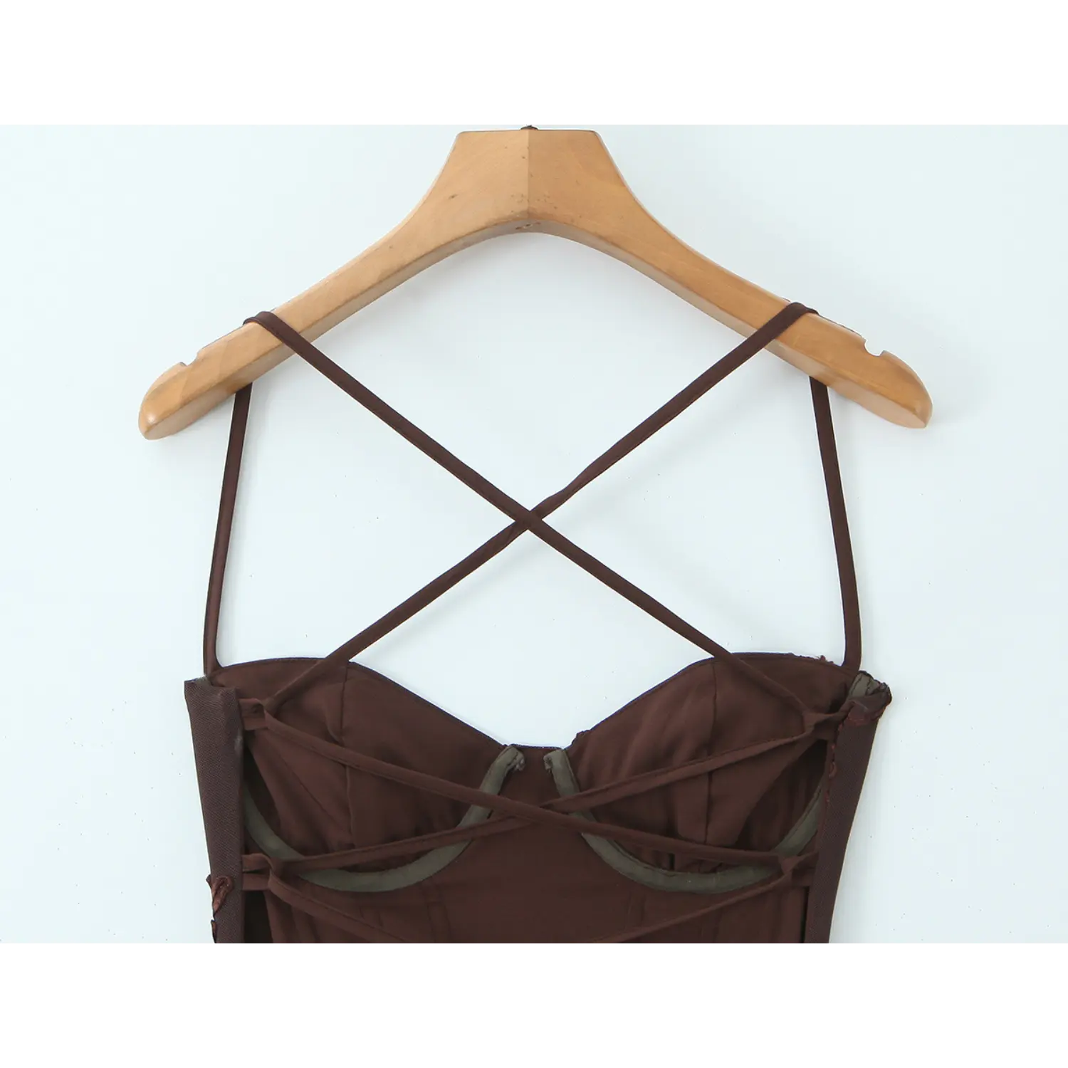 Back multi-layer cross lace-up inner structure macro close-up, matching satin straps drawstring adjuster invisible zipper neat serging inner craft shot