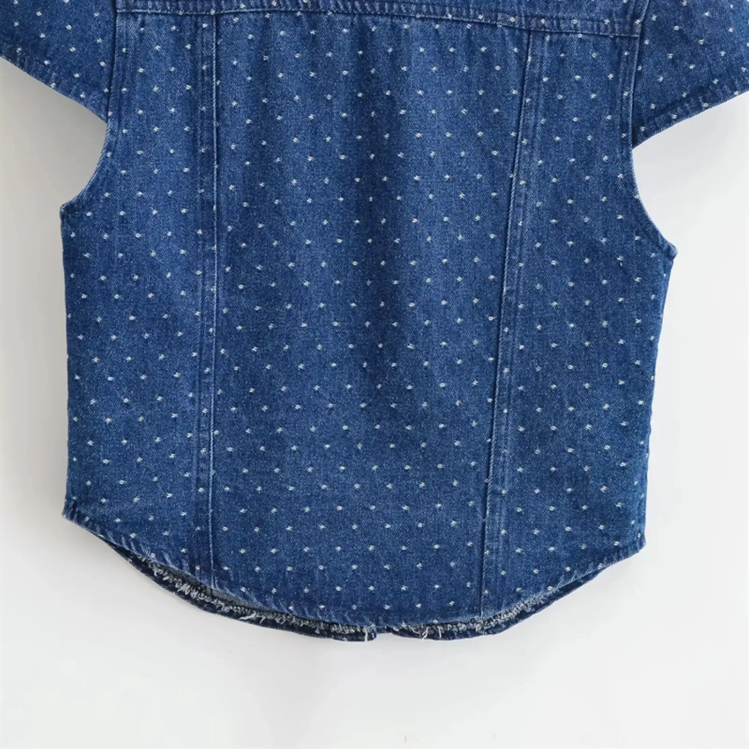 Full rear bottom hem partial view, curved raw frayed edge, side vertical shaping seams, lightweight washed denim drape