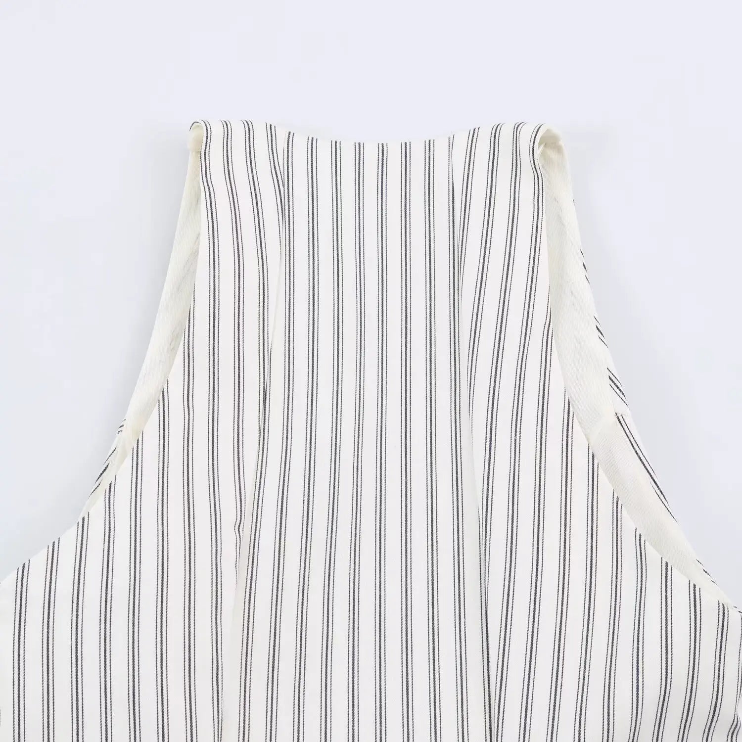 Back halter neck partial close-up, wide sleeveless halter frame, gathered stripe woven fabric texture