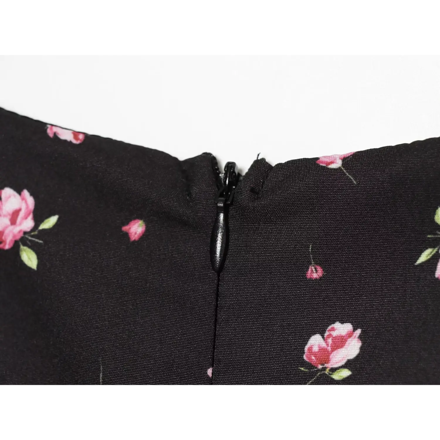 Macro close-up invisible back zipper detail on black pink rose print mini dress