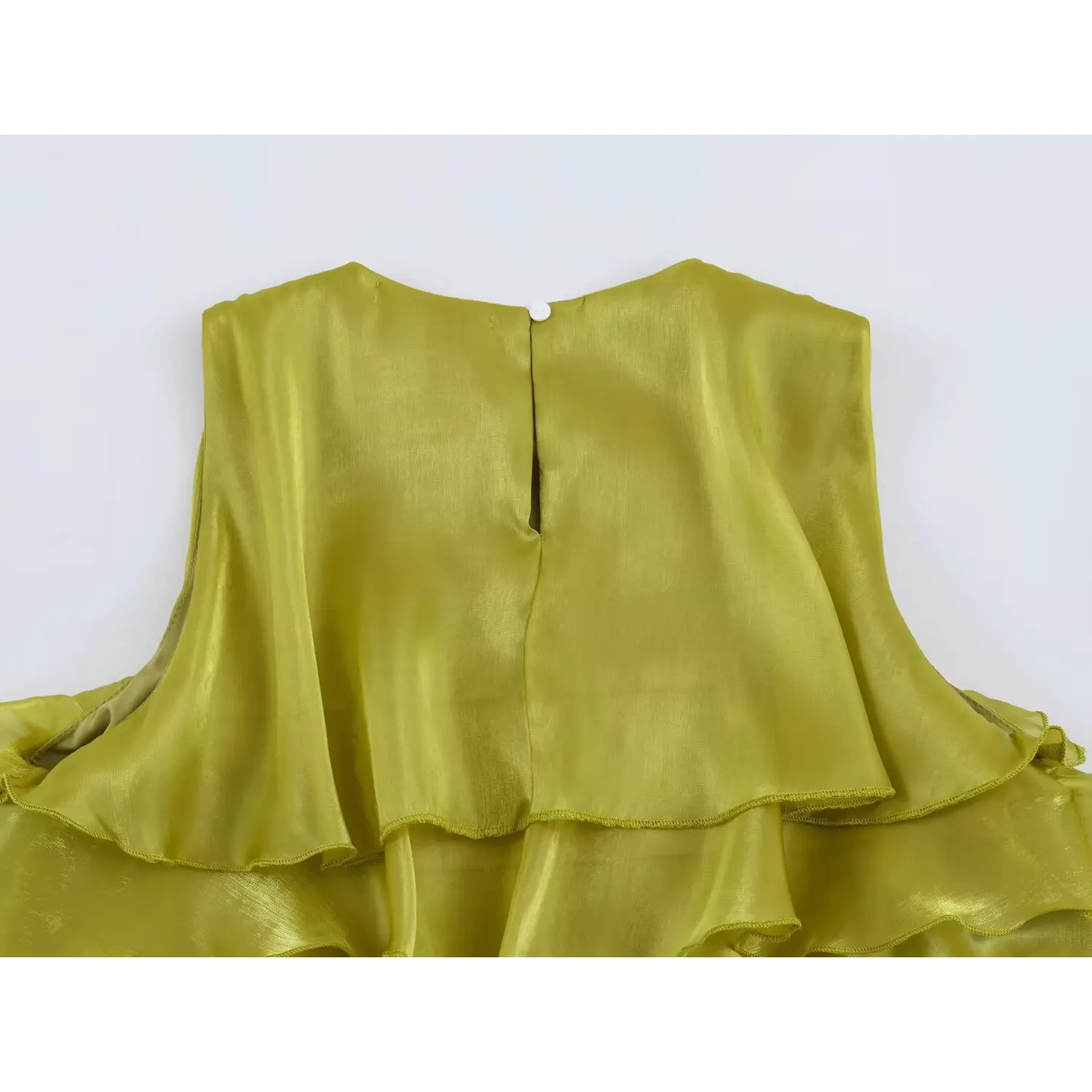 Close-up back keyhole opening with single button closure on chartreuse tiered sleeveless dress