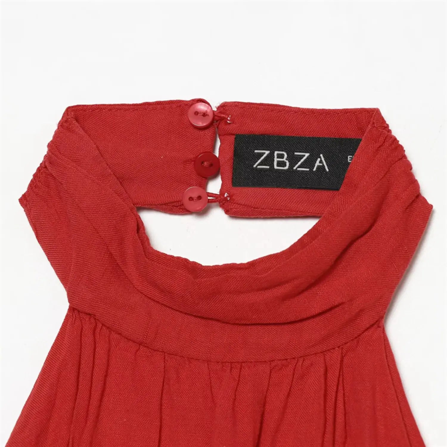 Back neckband macro shot, three matching red buttons, inner woven brand label, reinforced button placket