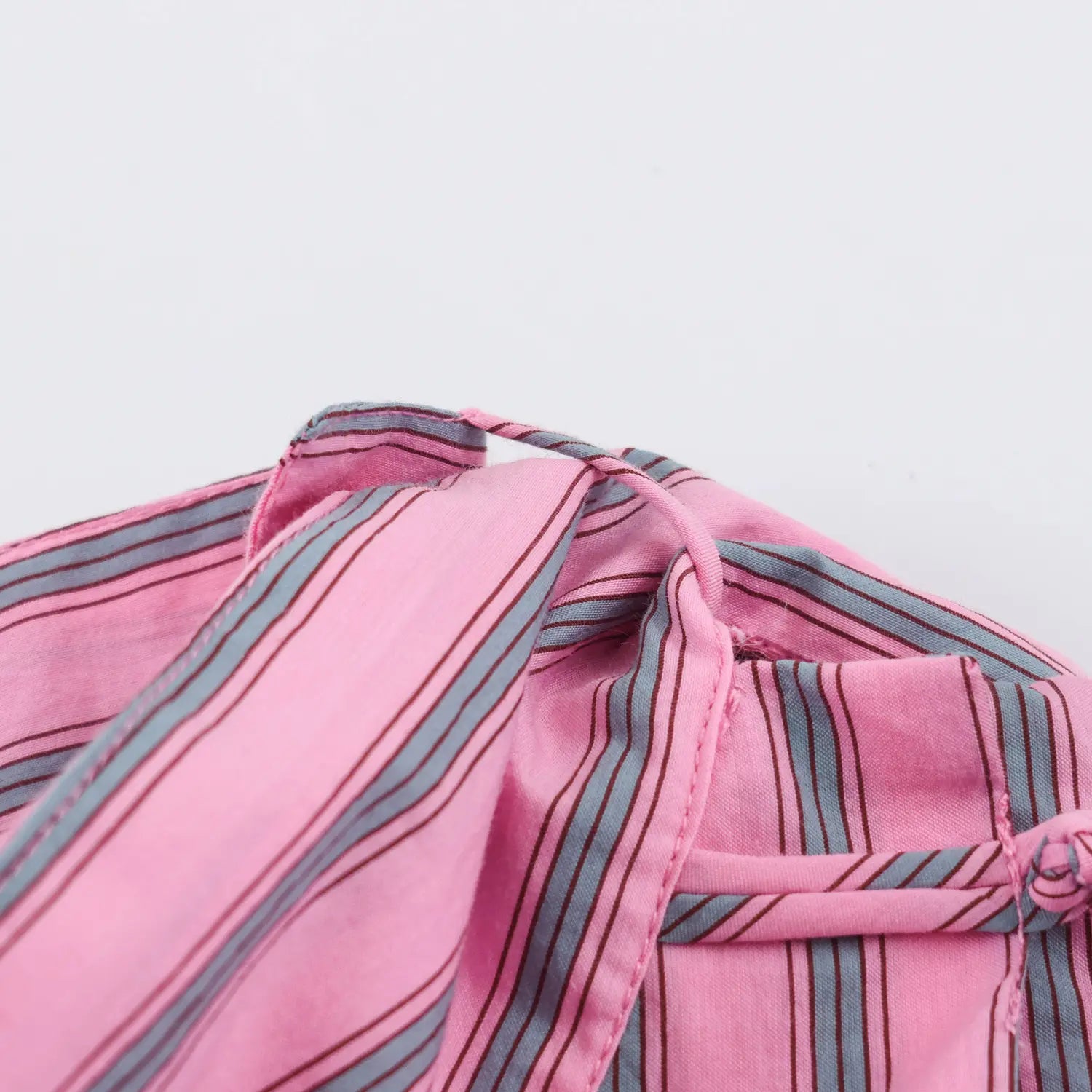Closeup rear neck attached long fabric tie, inner lining & neat seam finish