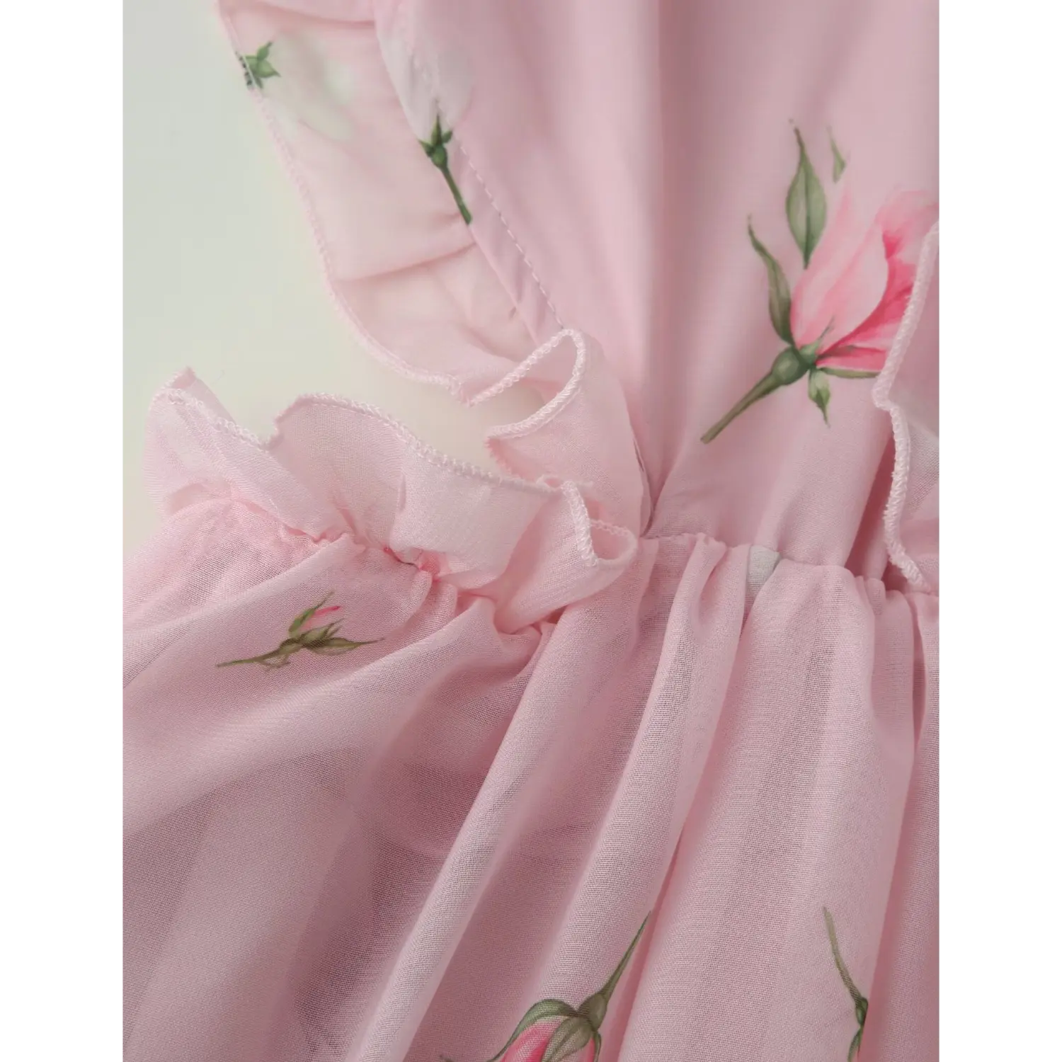 Back large hollow oval cutout partial shot, full perimeter ruffle edging, loose flowy fit