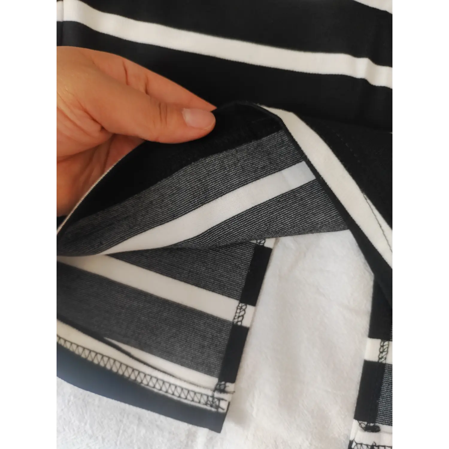 Close-up back slit fabric stitching of striped pencil skirt