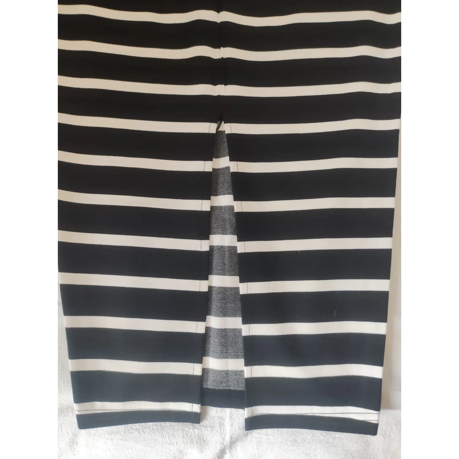 Detailed shot of bottom back slit hem stitching striped skirt