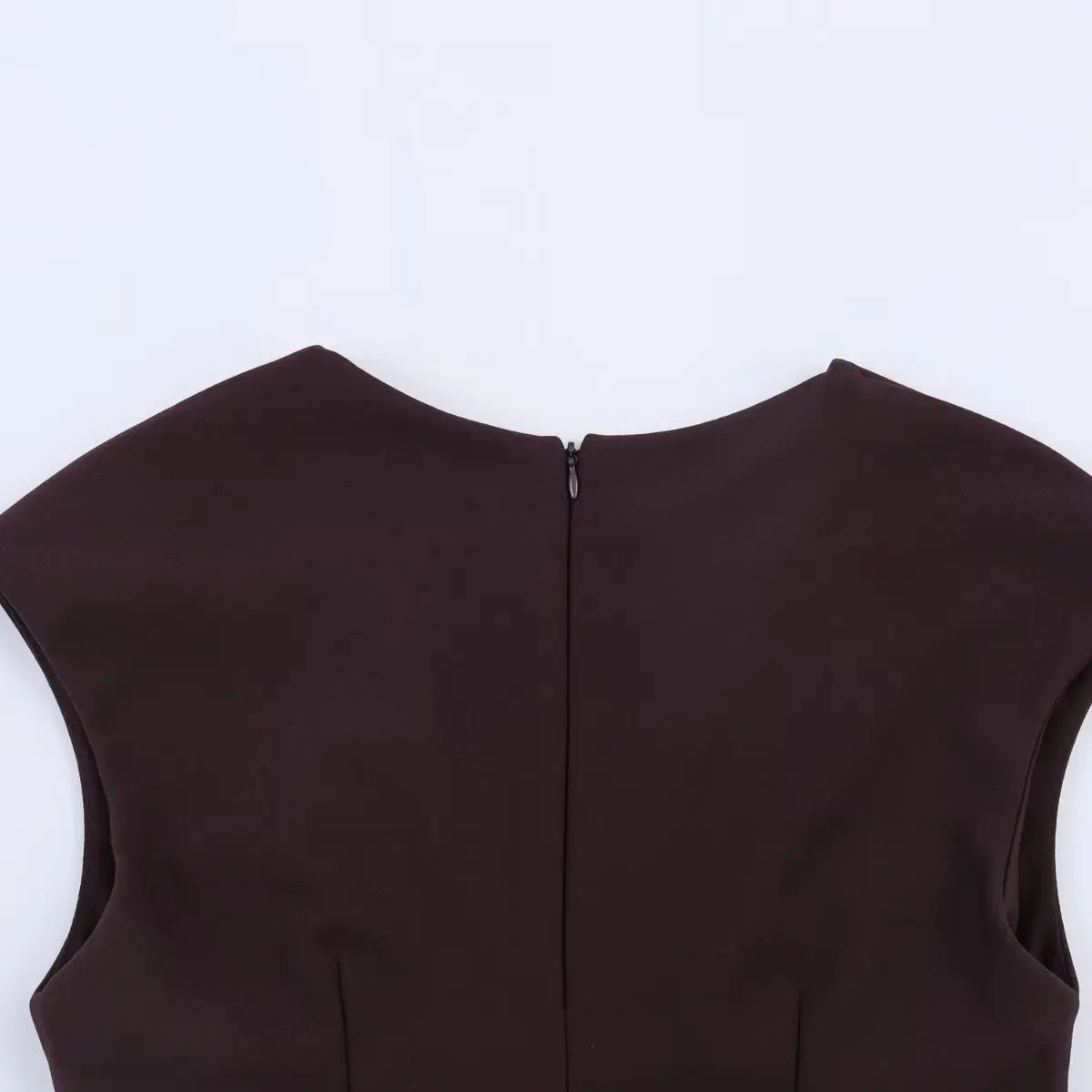 Close-up of the back neckline and hidden zipper closure on a brown V-neck cap sleeve mini dress.