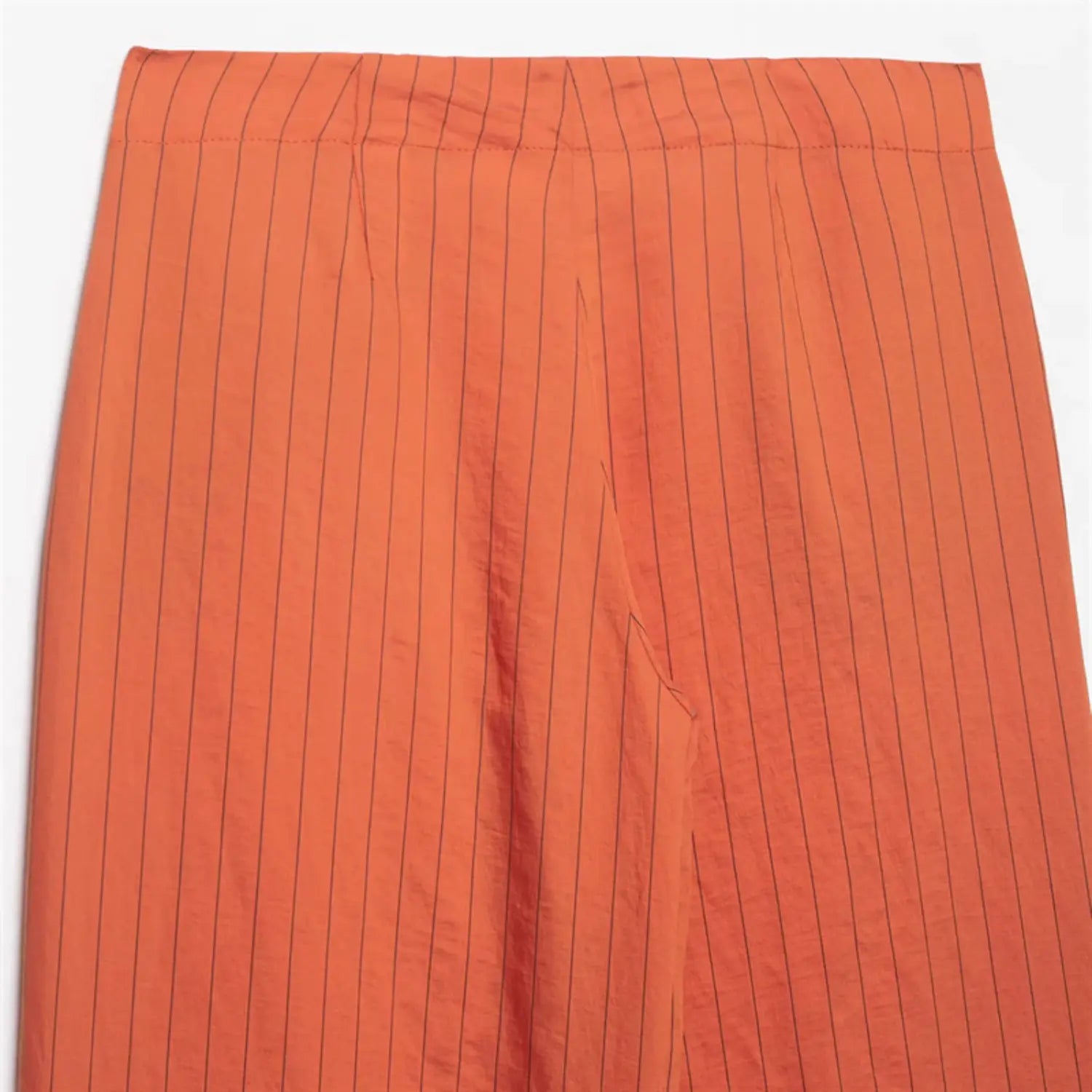 Rear waist macro close-up, full back waistband horizontal stitching, vertical stripe alignment, smooth matte fabric drape