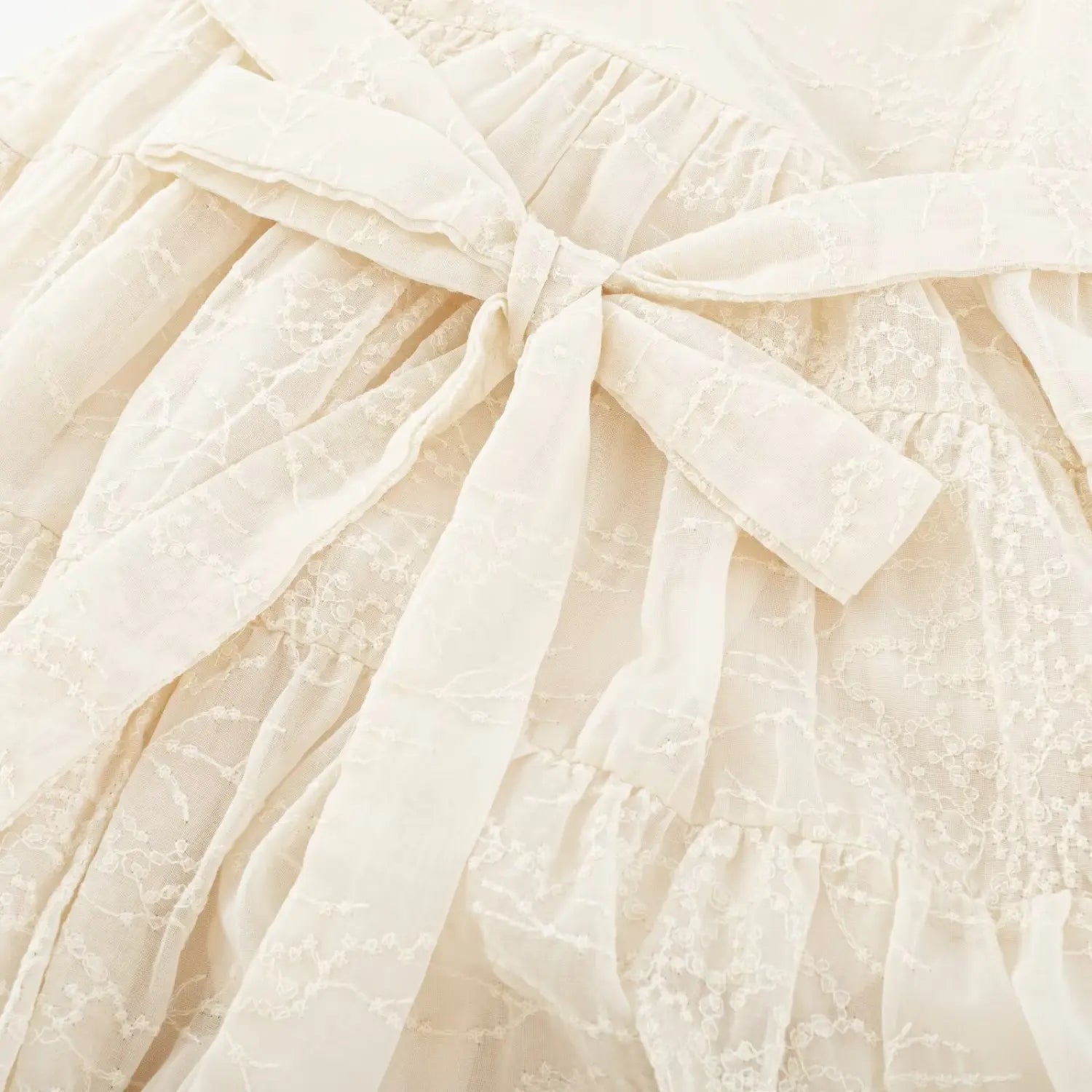 Back waist matching embroidered fabric wide bow tie sash macro close-up, free waist adjust shaping silhouette double woven tape neat binding craft shot