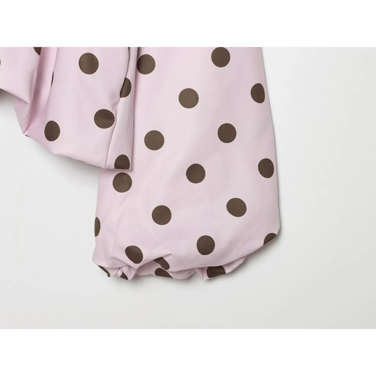 Long sleeve cuff close-up, relaxed balloon sleeve hem, smooth polka dot woven texture