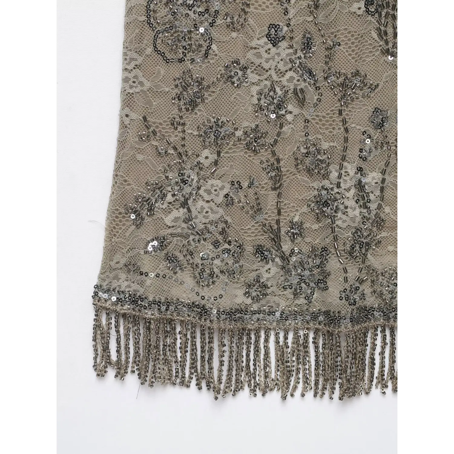 Extreme close‑up of bottom hem showcasing beaded fringe trim, sequin and floral bead embroidery on beige lace mesh