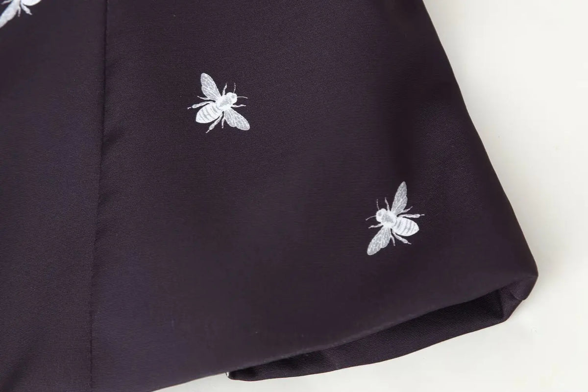 Close-up of long sleeve cuff and bee print