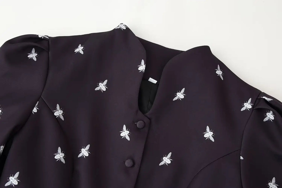 Close-up of stand collar and bee print