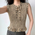 The top styled on a model, highlighting its fitted silhouette, tie neck, and ruffled hem.