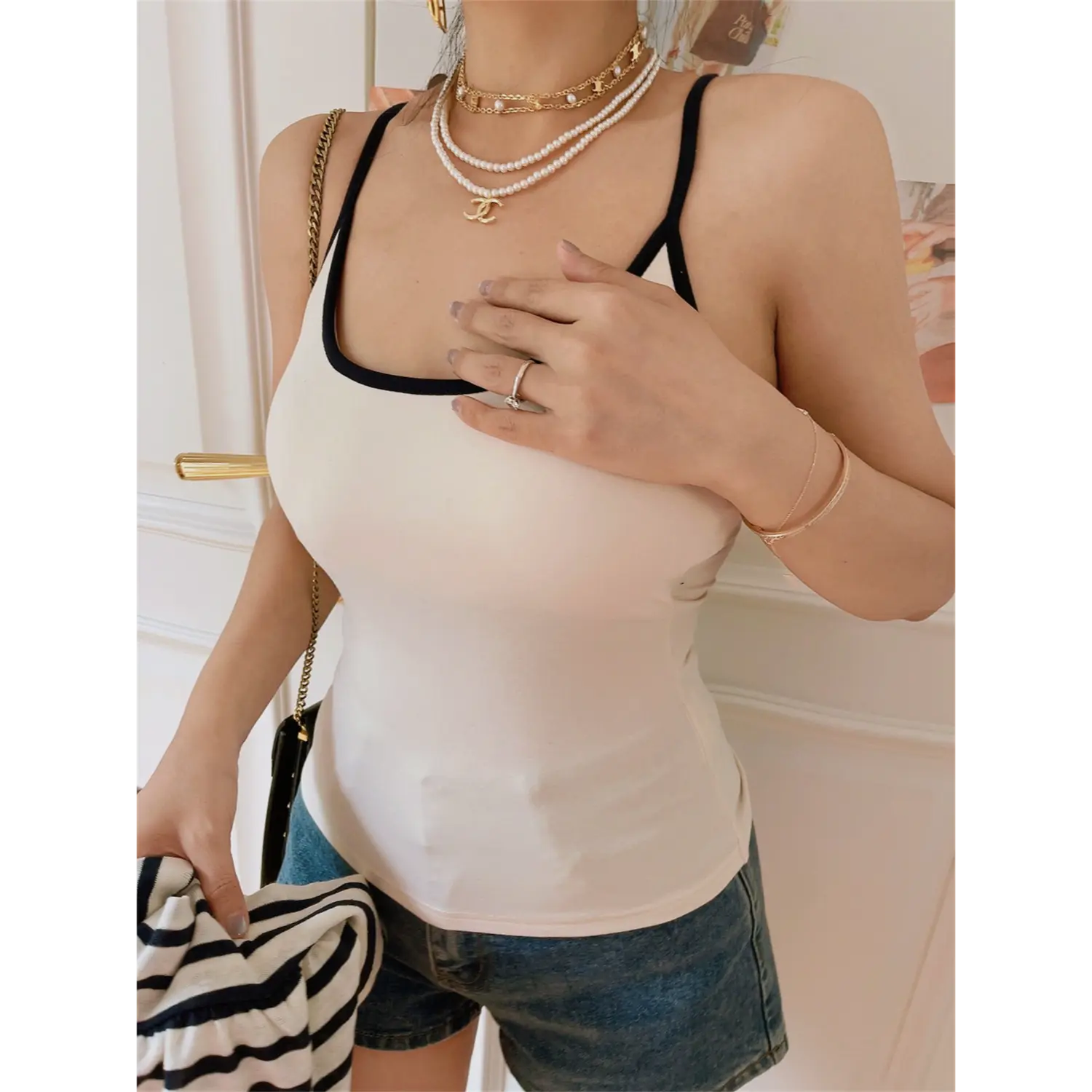 Model front medium shot of beige tank camisole with black contrast neck trim