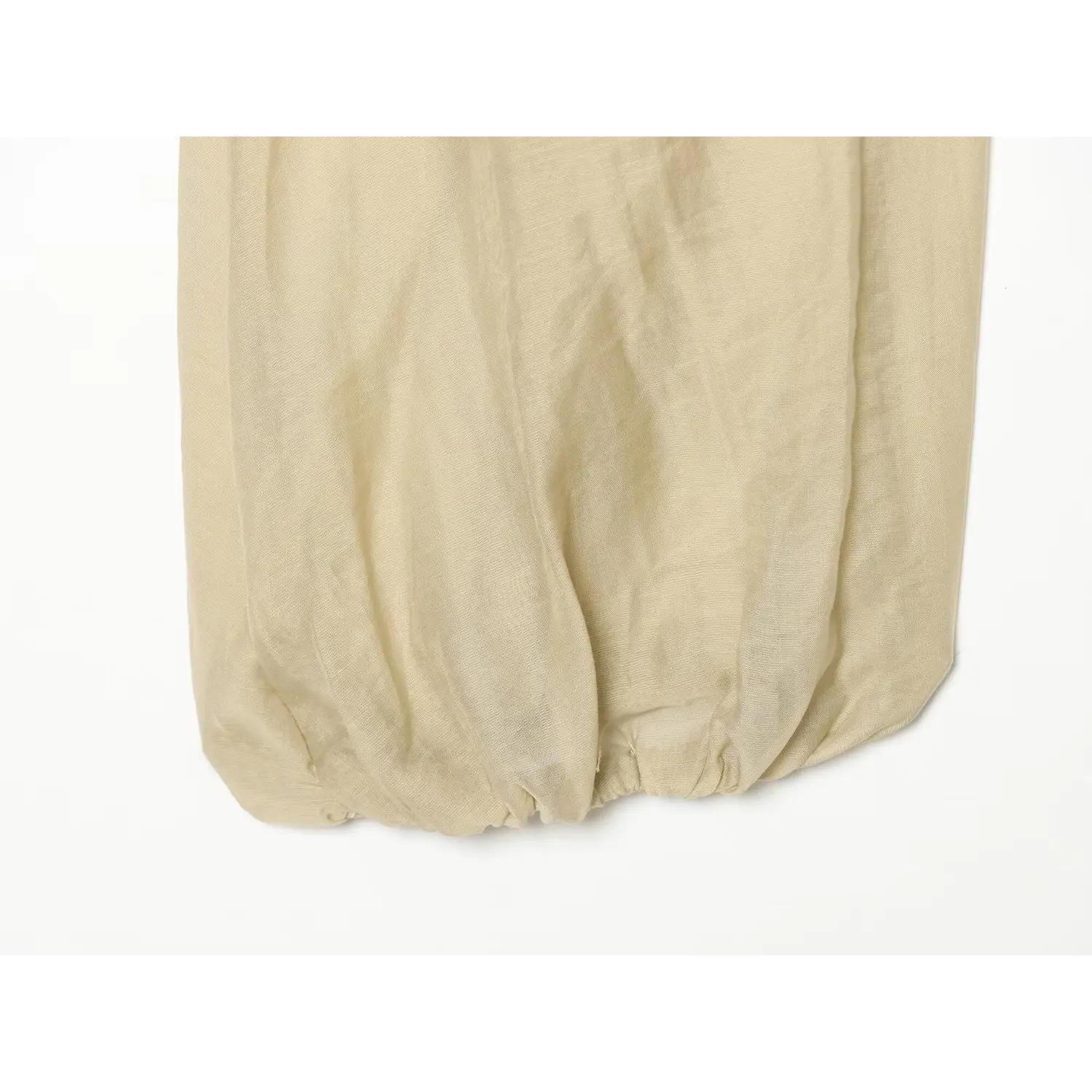 Close‑up elasticated balloon sleeve cuff of beige long sleeve crop blouse