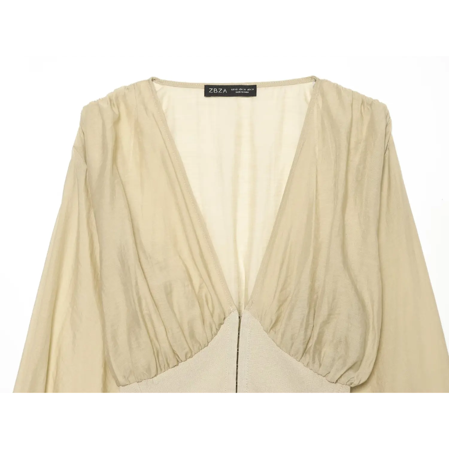 Close‑up view of deep v‑neck and gathered bust detail on beige corset crop top
