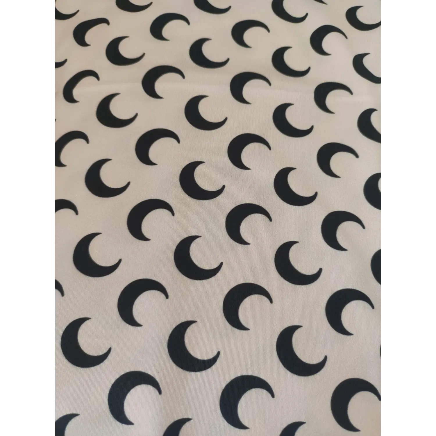 beige fabric with black crescent moon pattern close-up | Detail