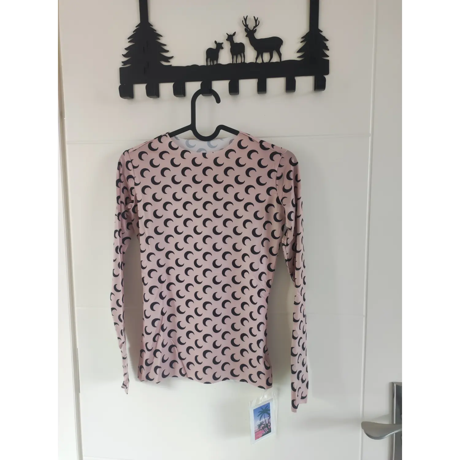 beige crescent moon long sleeve top front hanging shot | Detail