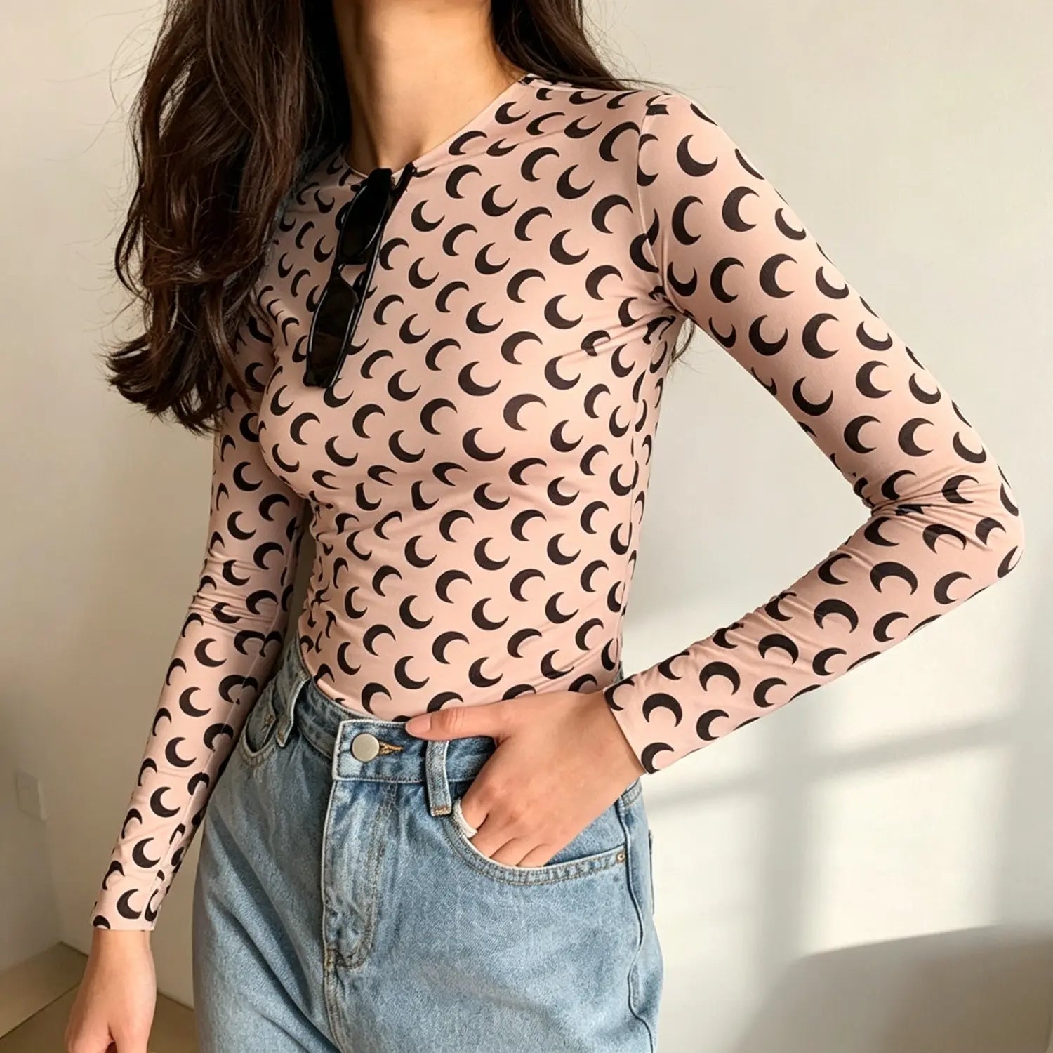 model wearing beige crescent moon print fitted long sleeve top | Detail