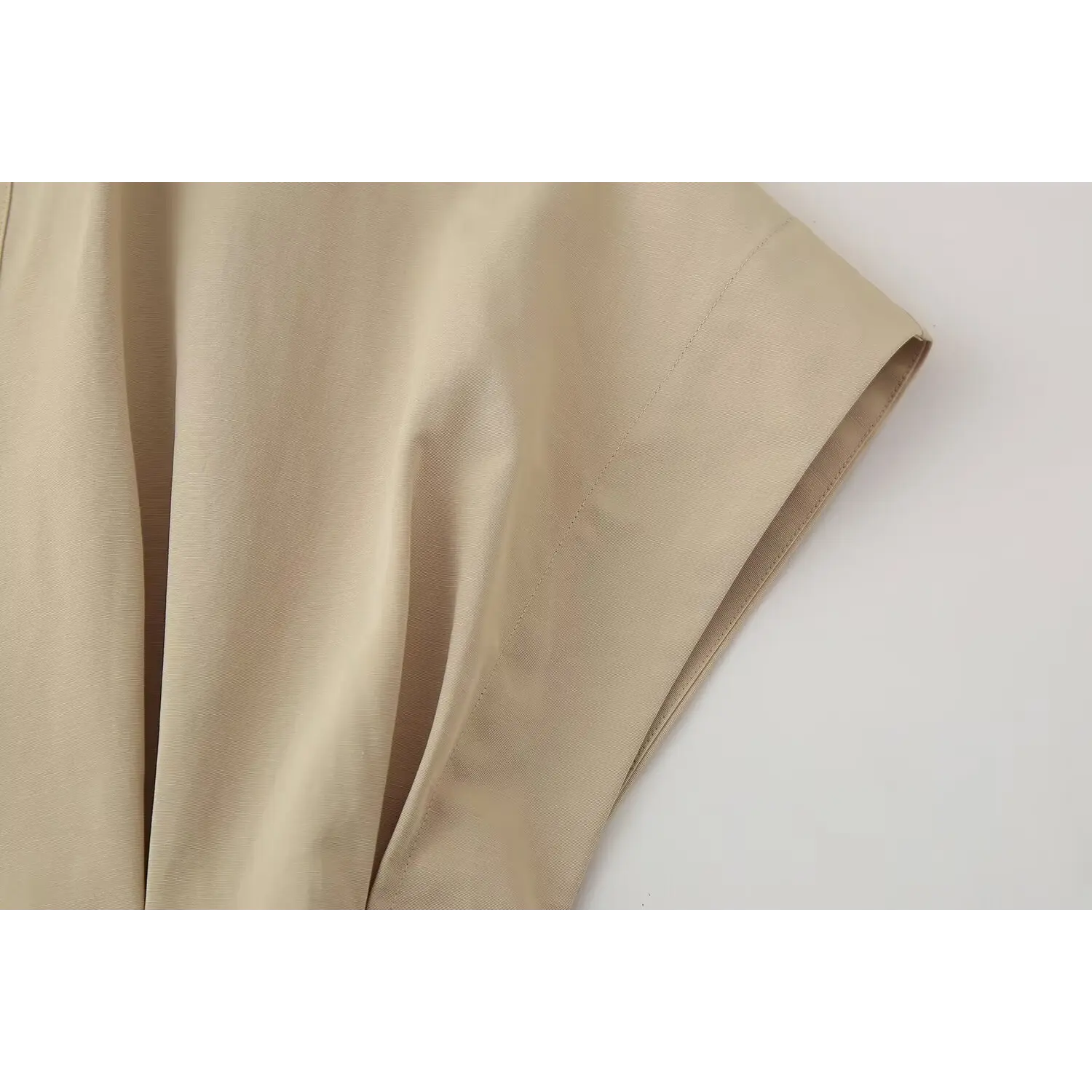 Macro shot batwing short sleeve finished hem and stitching of beige tailored mini dress