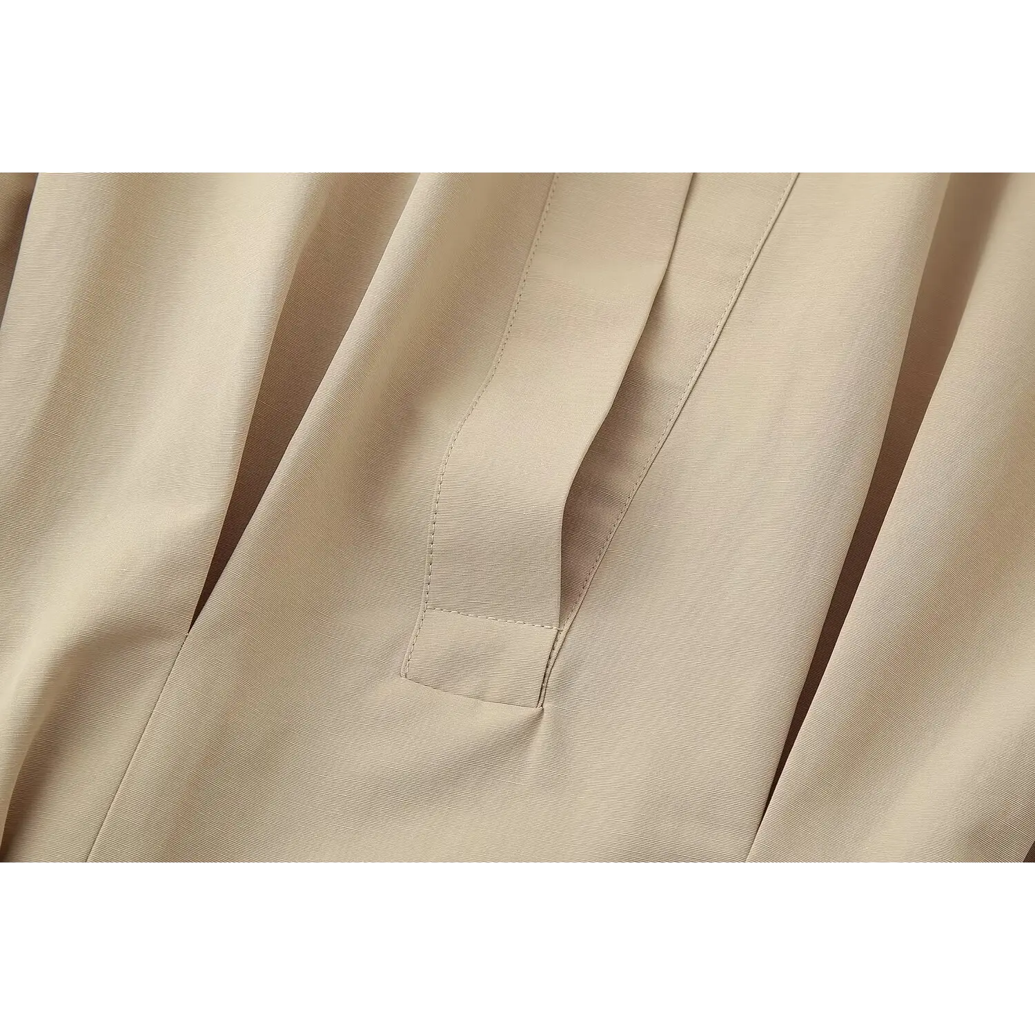 Detailed view front half placket neat seam stitching on beige belted mini dress