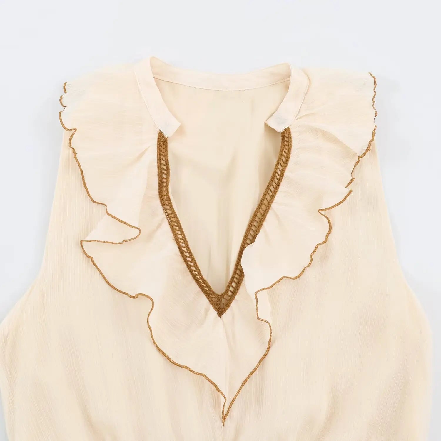 Close-up v-neck with ruffle trim and brown crochet piping on beige sleeveless maxi dress