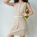  Lifestyle model outfit photo, sleeveless khaki layered blazer mini dress with matching white waist belt, paired with lime green shoulder bag and delicate silver chain necklace, minimalist office casual styling