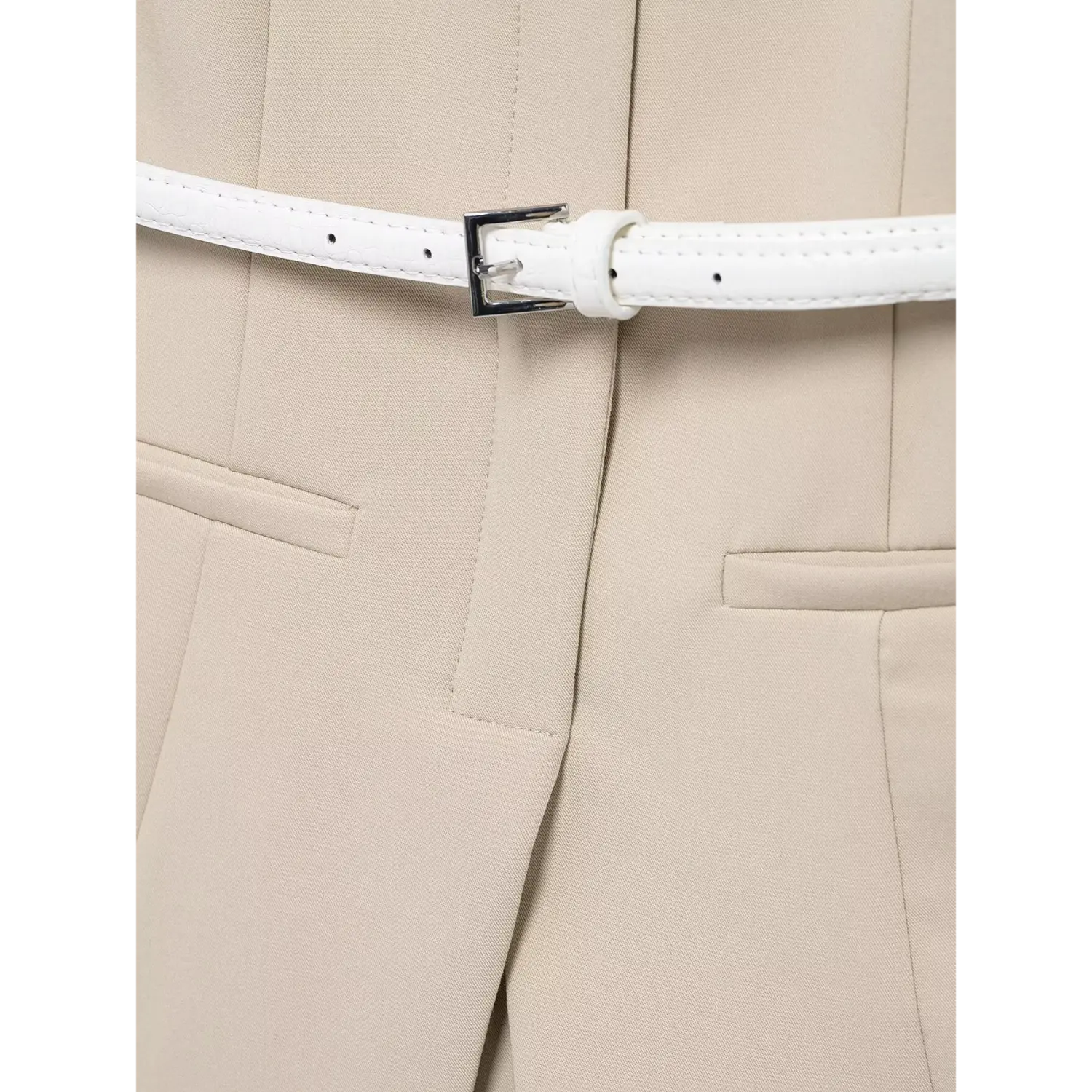Macro shot of thin white crocodile embossed leather belt, square polished silver metal pin buckle, multiple size adjustment eyelets