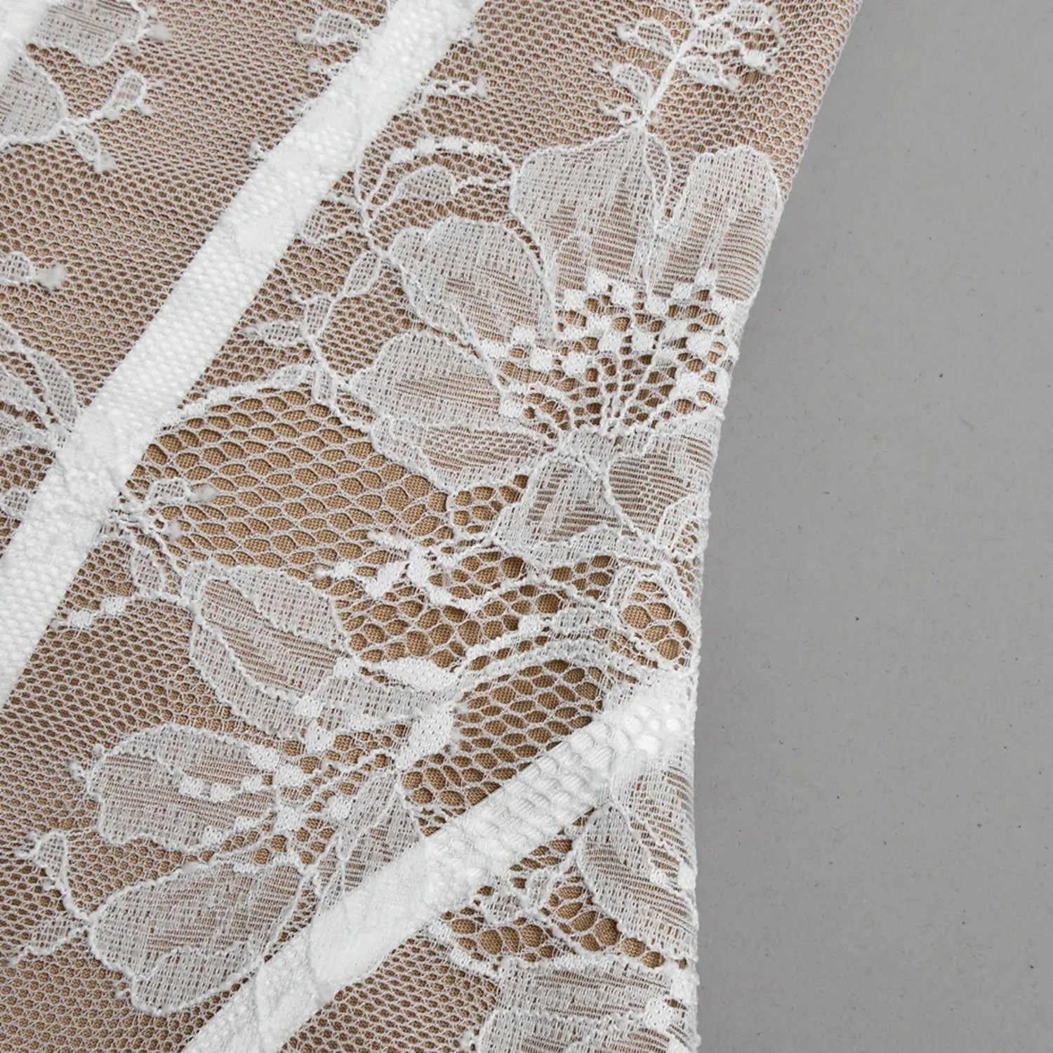 Texture close‑up white floral lace overlay beige mesh fabric weave detail