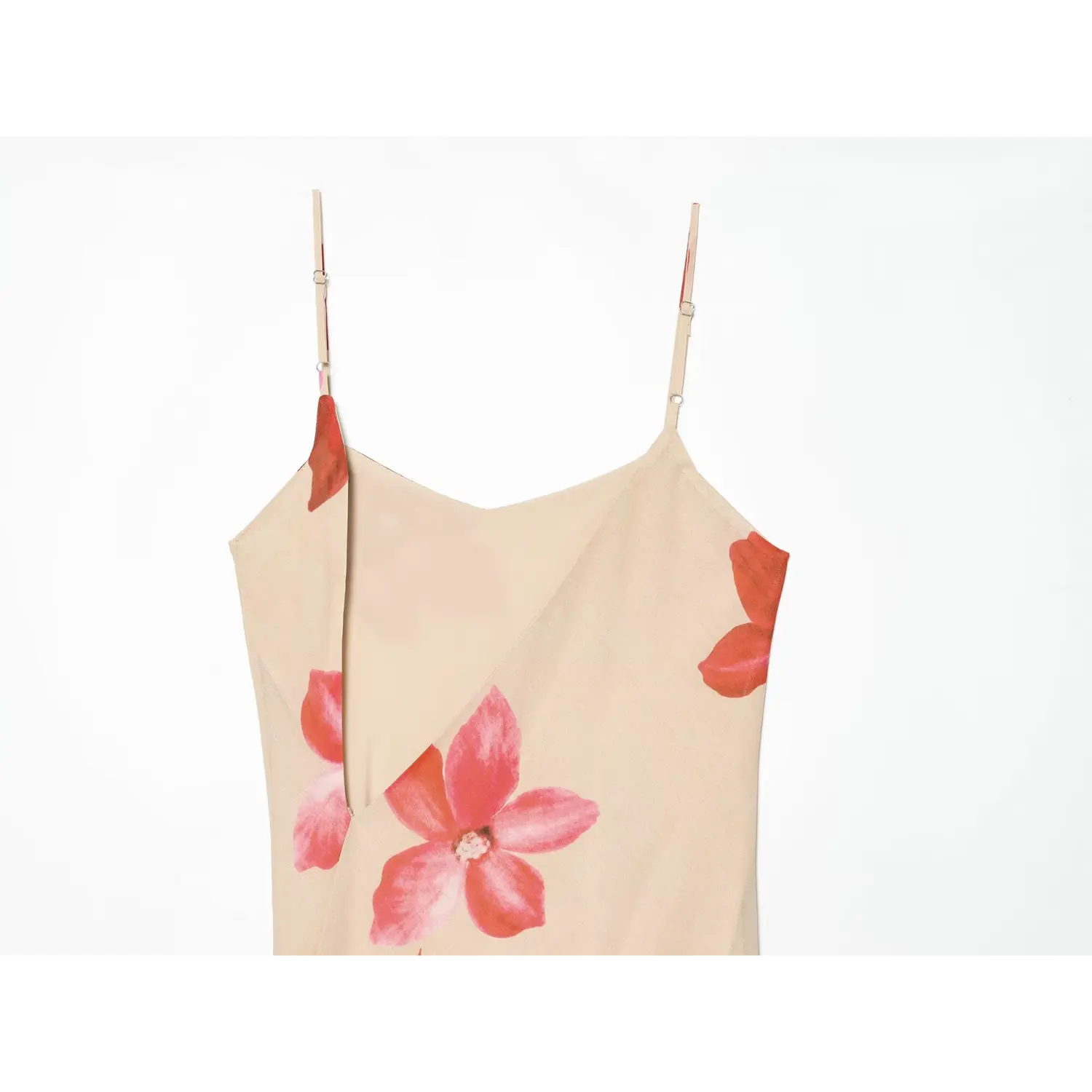 Close-up of beige maxi dress bust split detail, red pink orchid print, adjustable straps, soft drape
