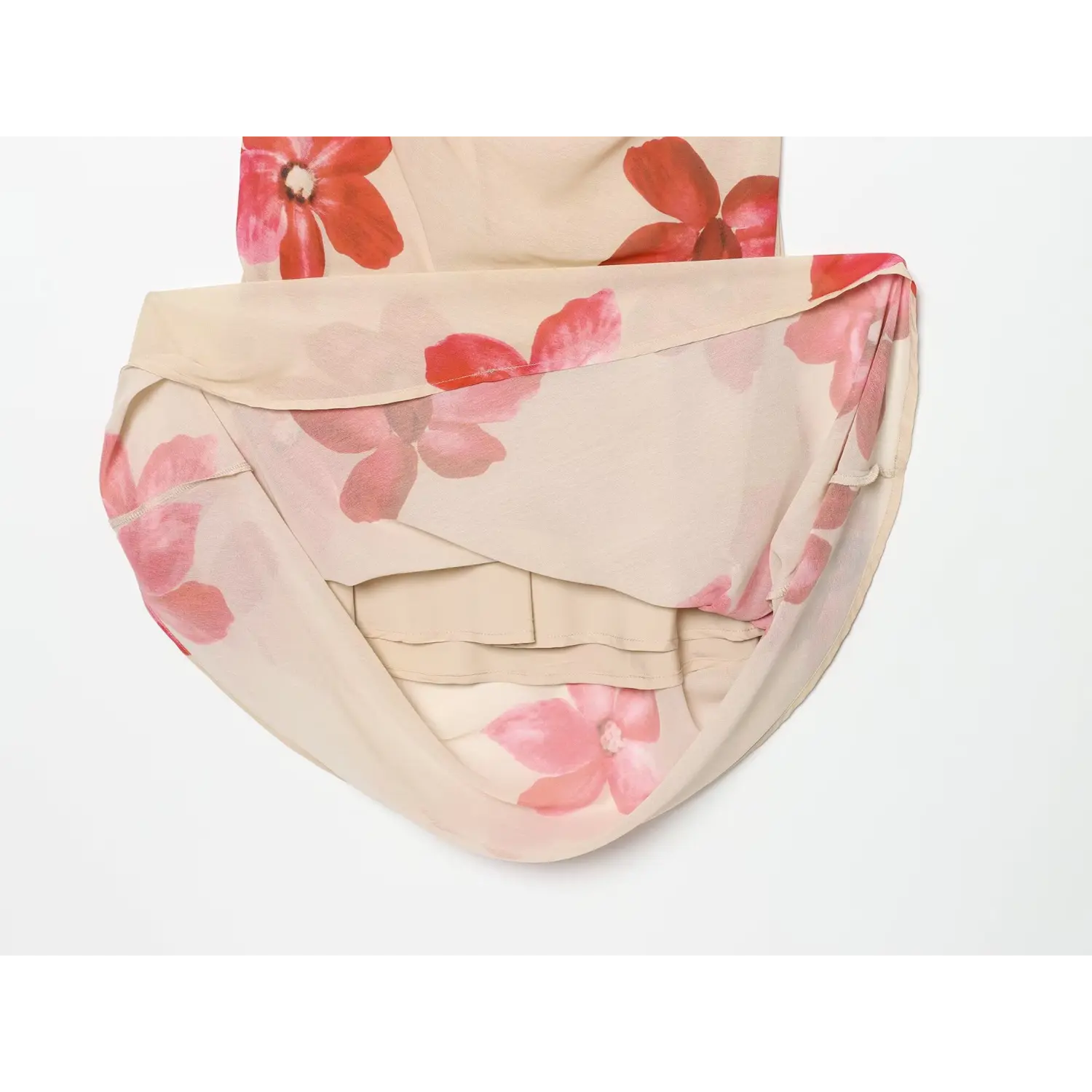 Close-up of beige floral maxi dress slit and inner lining, red pink flower print, layered chiffon hem