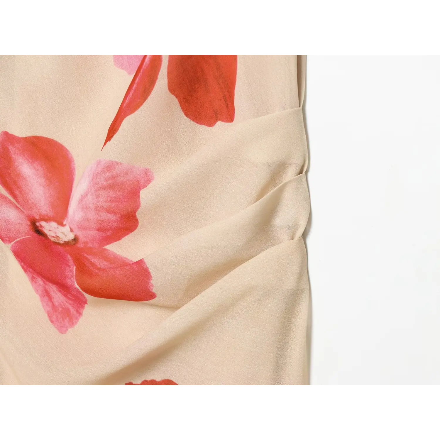 Close-up of waist ruching on beige floral maxi dress, red pink orchid print, soft crepe texture