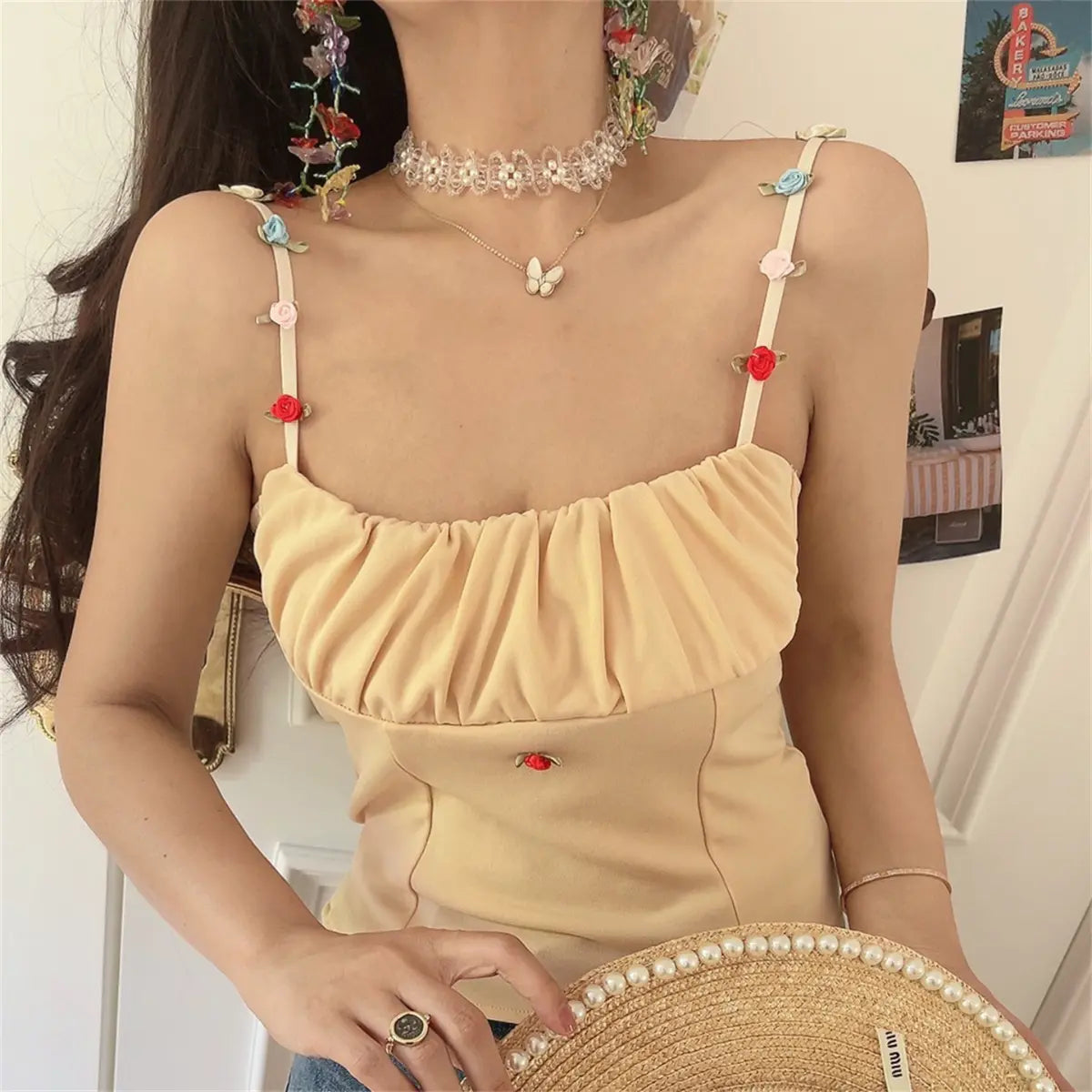 The beige floral-strap cami top paired with blue jeans, showing a casual styling.
