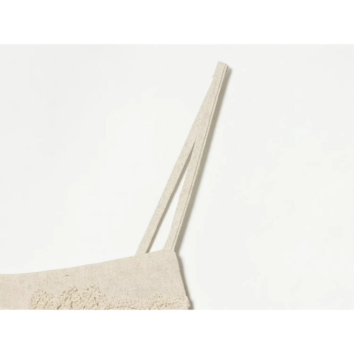 Close-up of thin double spaghetti straps on beige linen dress