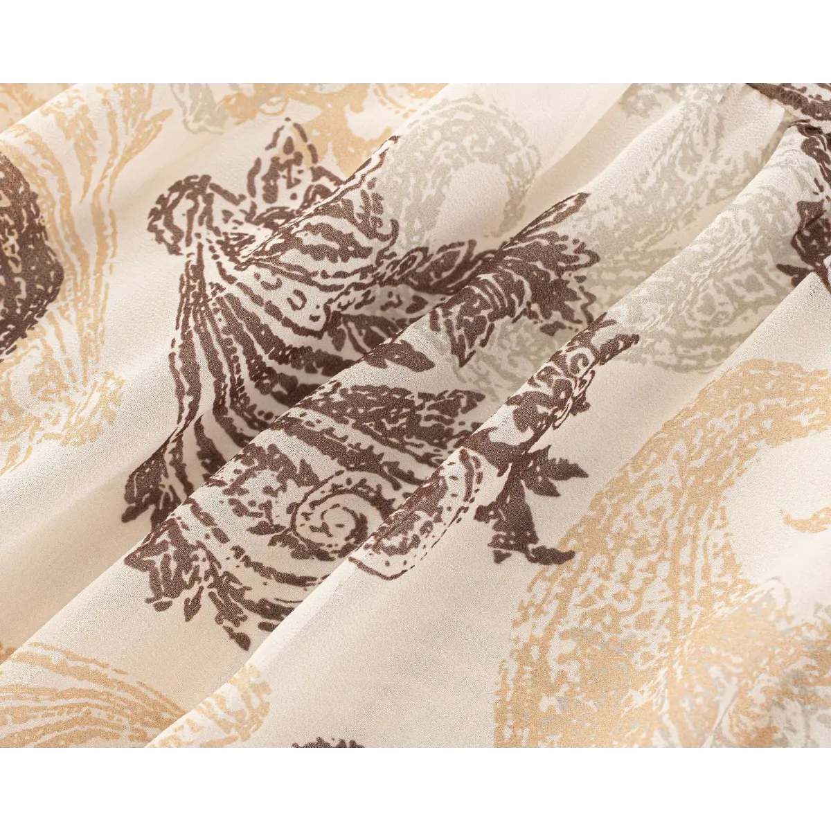 Close-up of the soft paisley print and lightweight fabric texture on the beige skirt.