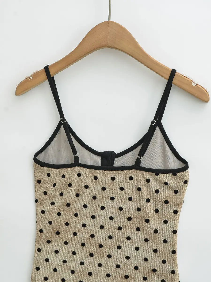 Close-up of the back view of the beige polka dot cami top, highlighting adjustable spaghetti straps and mesh lining