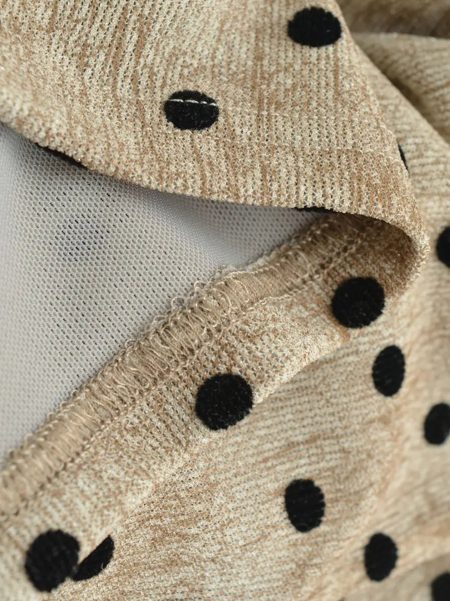 Close-up of the velvet-like polka dot fabric, mesh lining, and finished seam on the beige cami top
