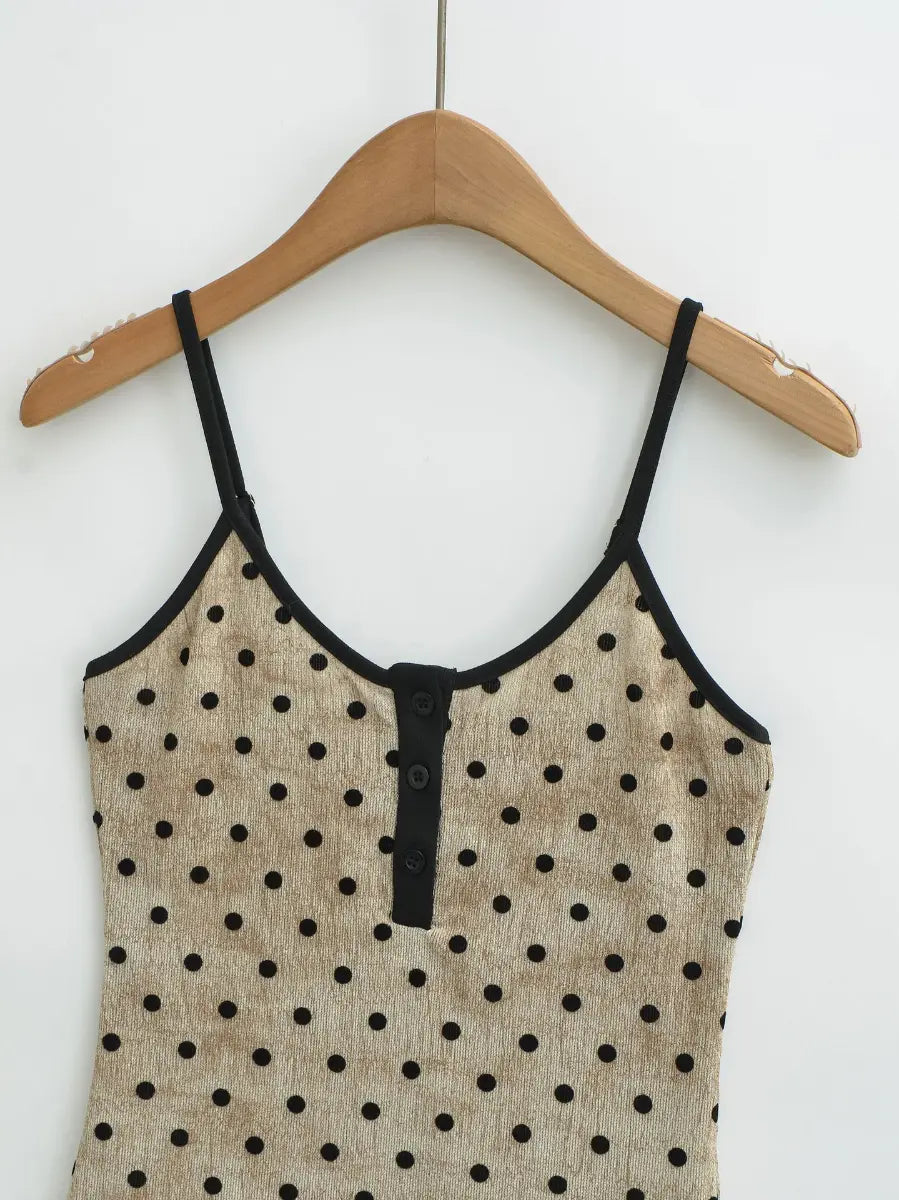 Close-up of the front henley-style button placket on the beige polka dot cami top