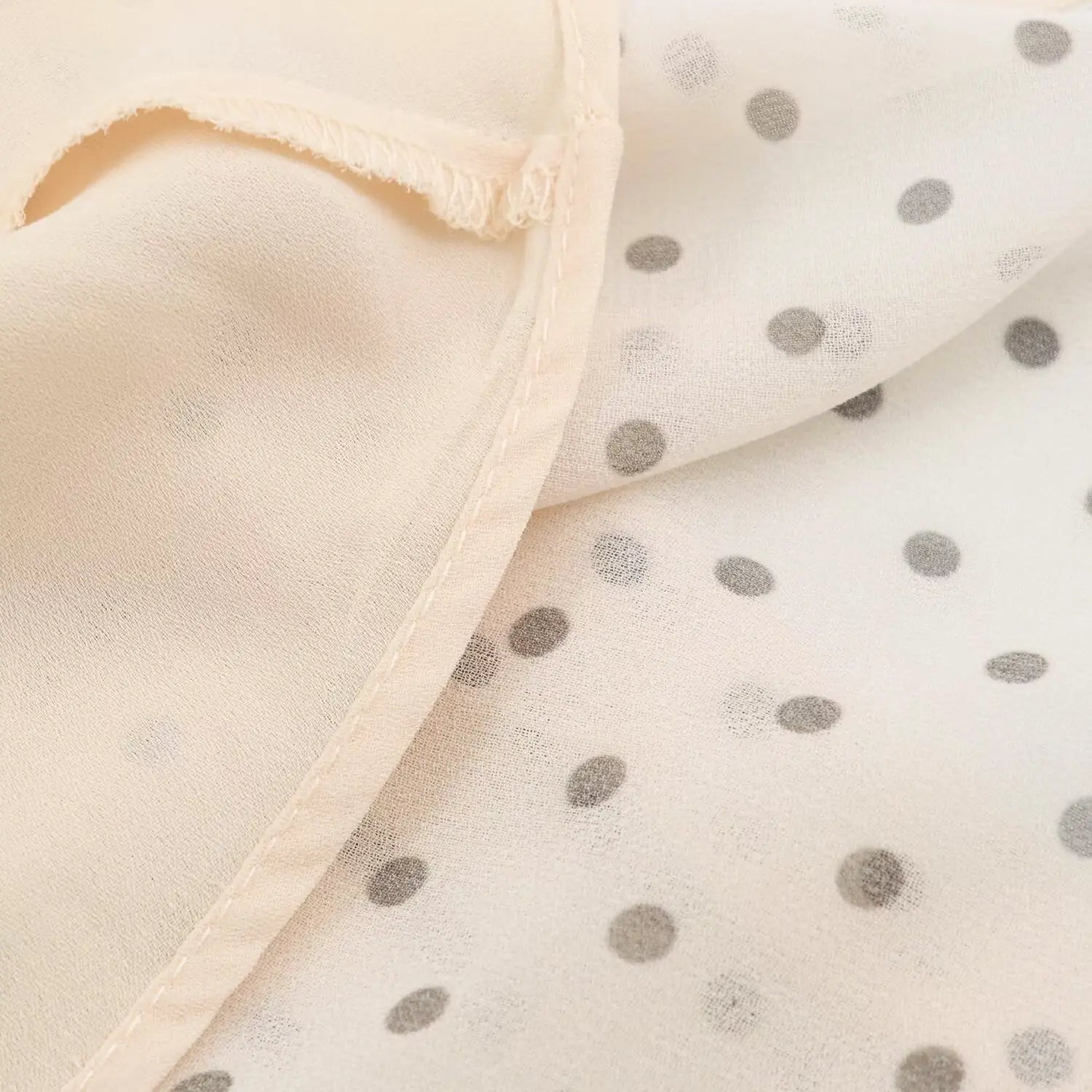 Close‑up of inner lining and seam workmanship of beige polka dot maxi dress