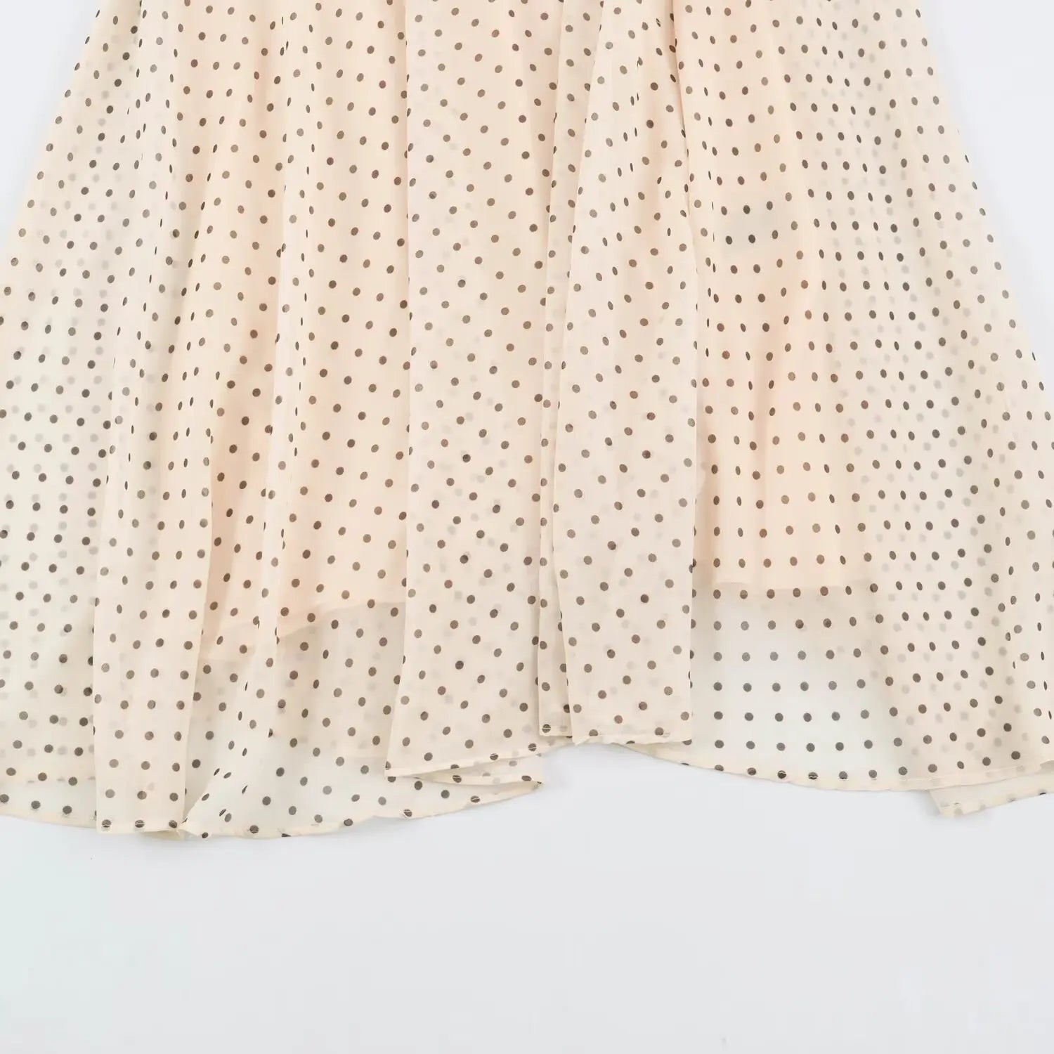 Overlay skirt detail of beige polka dot halter maxi dress, flowy chiffon hem