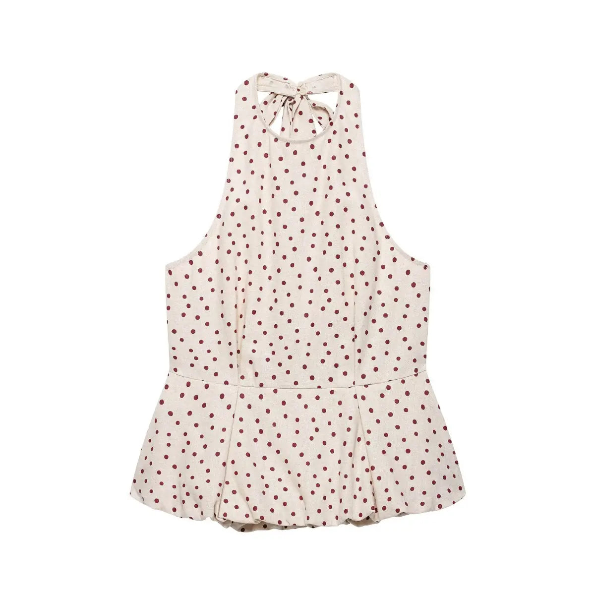 Flat lay view of a beige halter peplum top with red polka dots, featuring a back tie closure and flared peplum hem.
