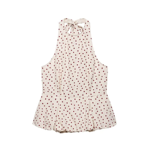 Flat lay view of a beige halter peplum top with red polka dots, featuring a back tie closure and flared peplum hem.