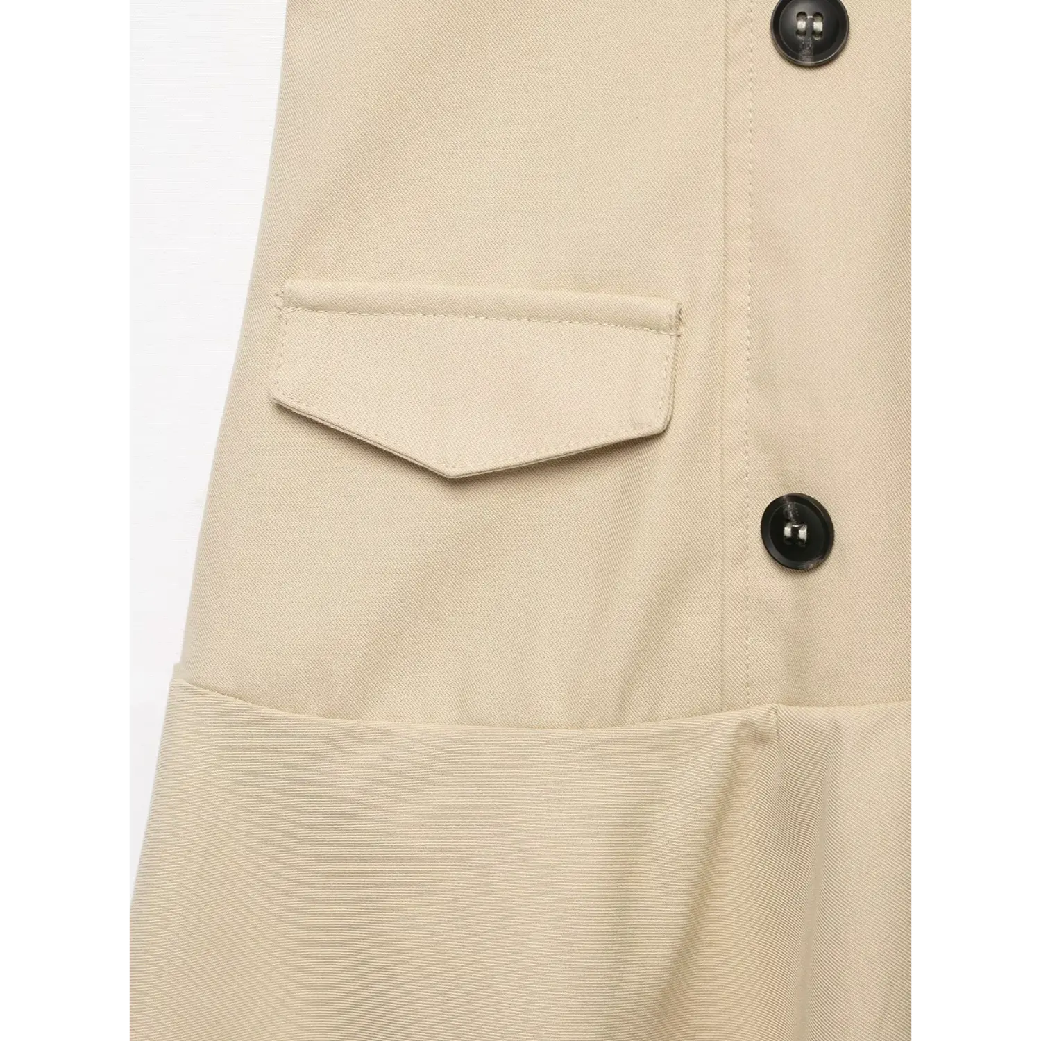 Close‑up of front patch pocket and black button detail on beige sleeveless trench mini dress, twill fabric texture