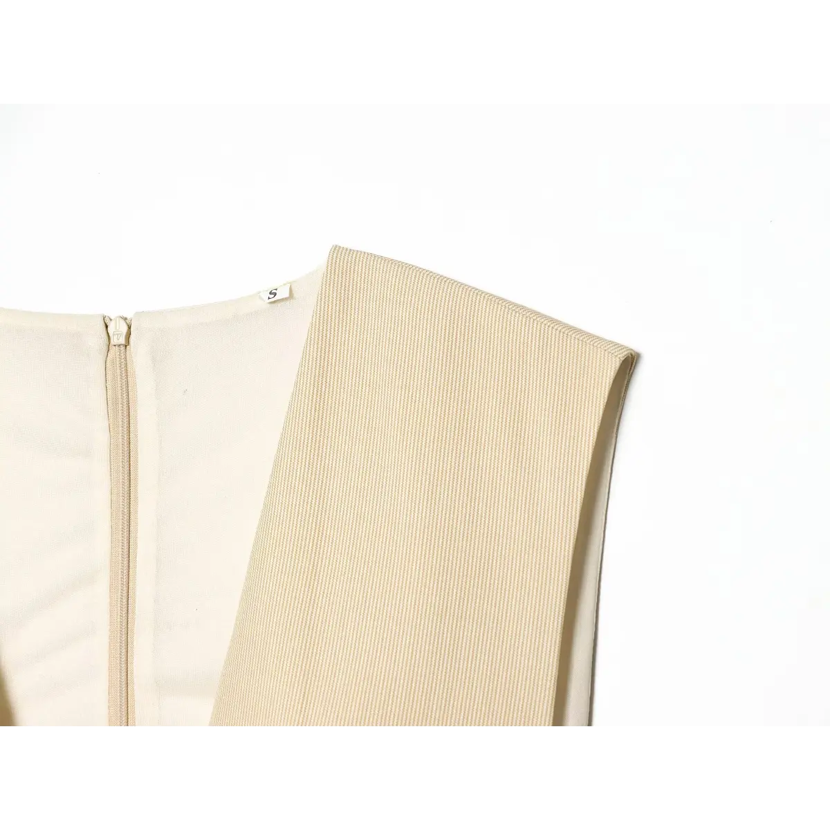 Close-up of the back neckline and zipper on the beige fine-striped dress