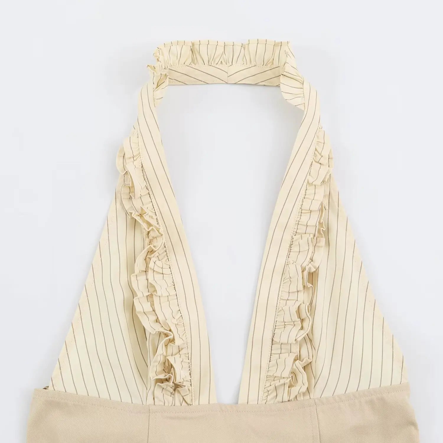 Close-up of vertical ruffle trim along deep V neck of beige striped halter dress
