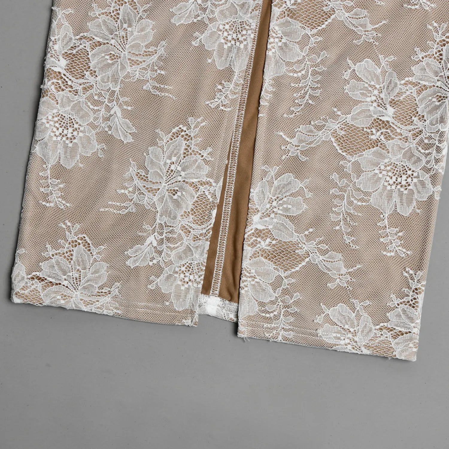 Close‑up flat shot back hem slit detail white floral lace over beige lining maxi dress