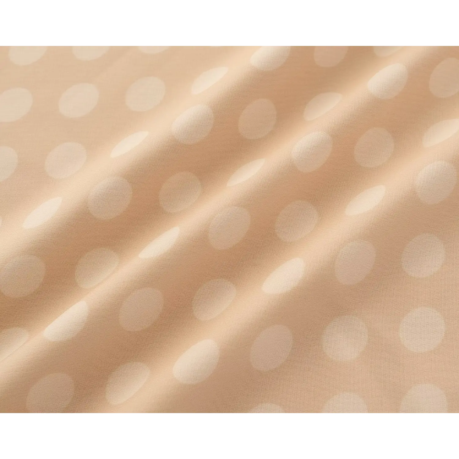 Close‑up draped fabric texture of lightweight chiffon with beige base and soft white polka dot print